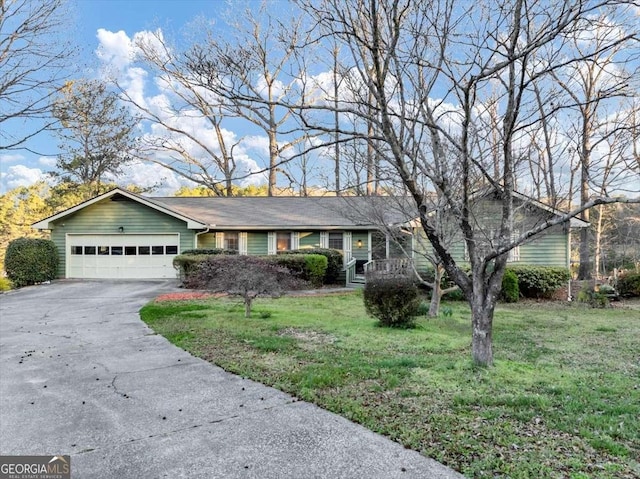 single story home with a front yard, concrete driveway, and an attached garage