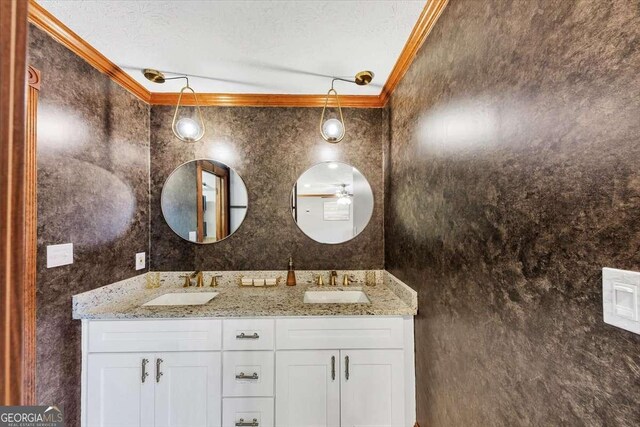 full bathroom featuring double vanity, a textured ceiling, and a sink