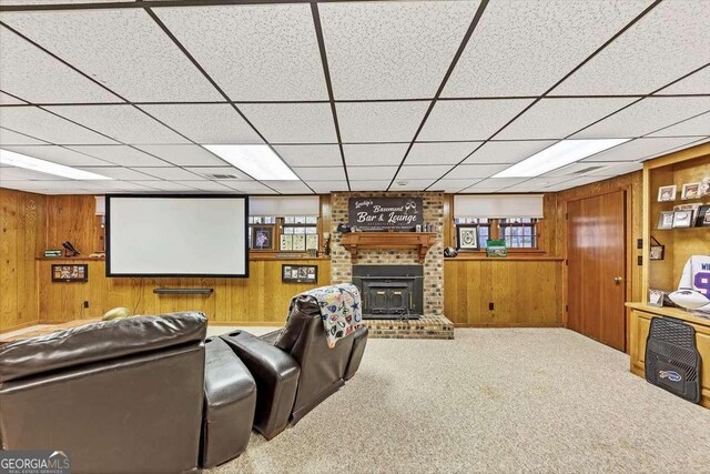 carpeted home theater with wooden walls