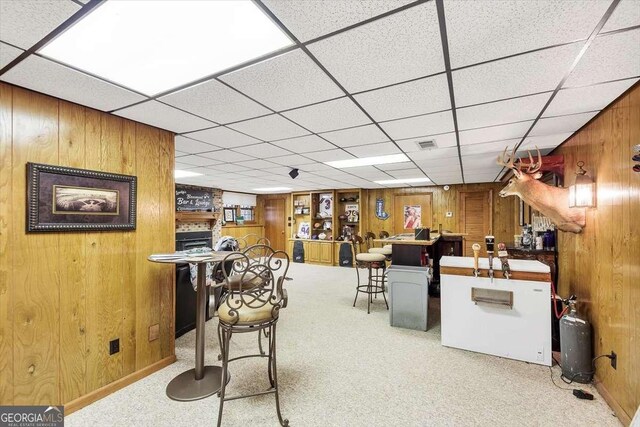 bar with carpet floors, wooden walls, and visible vents