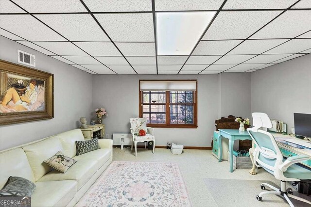 carpeted office with baseboards, visible vents, and a drop ceiling