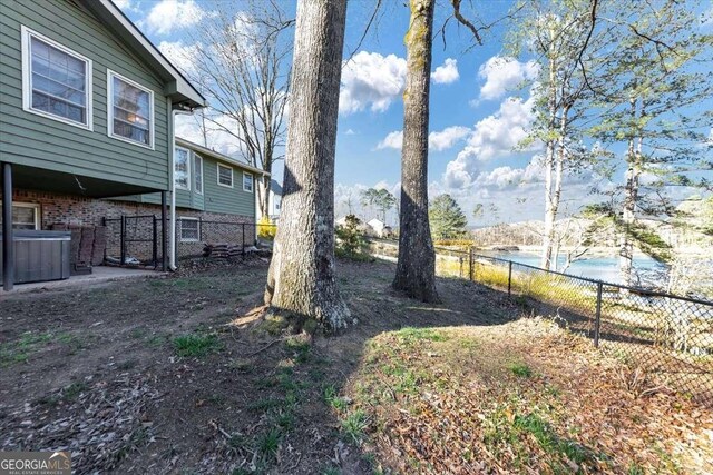 view of yard featuring a water view and fence