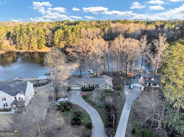 aerial view featuring a water view and a forest view