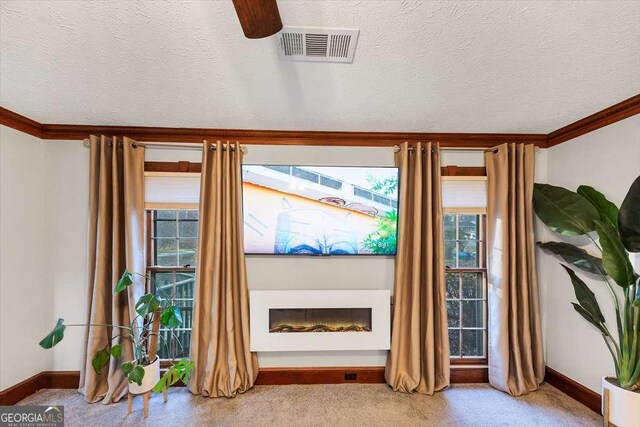 living room featuring a textured ceiling, visible vents, and plenty of natural light