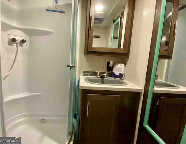 full bathroom with a shower and vanity