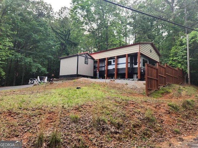 view of front facade with a view of trees and an outdoor structure