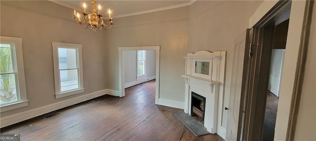 807 Elizabeth St, Waycross, GA 31503 - unfurnished living room featuring baseboards, dark wood-style flooring, ornamental molding, and a notable chandelier