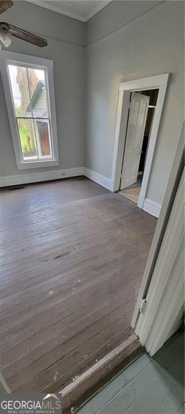 807 Elizabeth St, Waycross, GA 31503 - unfurnished room with baseboards, ornamental molding, wood finished floors, and a ceiling fan