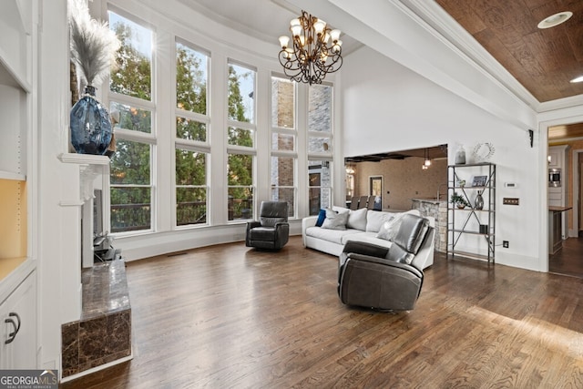 3491 Falls Branch Ct, Buford, GA 30519 - living room featuring plenty of natural light, wood finished floors, a chandelier, a high end fireplace, and a towering ceiling