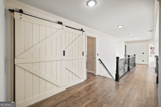 3491 Falls Branch Ct, Buford, GA 30519 - hall featuring a barn door, an upstairs landing, ornamental molding, wood finished floors, and recessed lighting
