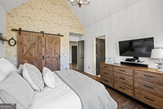 3491 Falls Branch Ct, Buford, GA 30519 - bedroom with high vaulted ceiling, a barn door, and dark wood-style flooring