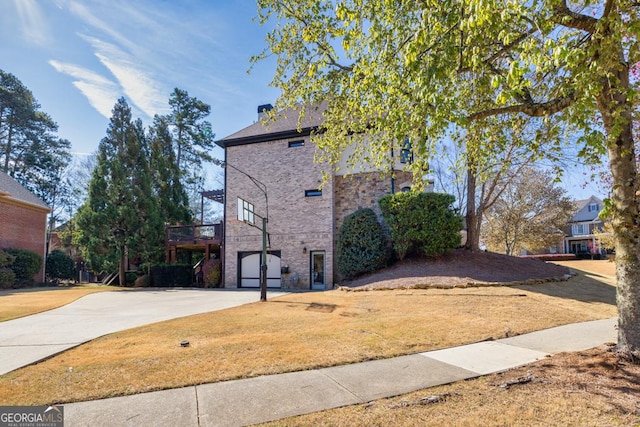 3491 Falls Branch Ct, Buford, GA 30519 - view of side of home with driveway, stone siding, and a lawn