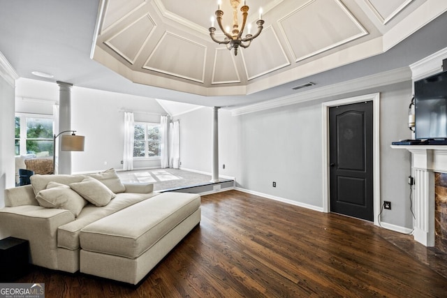 3491 Falls Branch Ct, Buford, GA 30519 - living room with ornate columns, dark wood-style floors, a chandelier, a tiled fireplace, and baseboards
