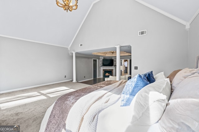 3491 Falls Branch Ct, Buford, GA 30519 - carpeted bedroom with a warm lit fireplace, high vaulted ceiling, decorative columns, crown molding, and baseboards