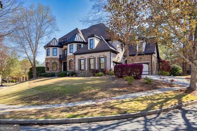 3491 Falls Branch Ct, Buford, GA 30519 - view of front of home featuring an attached garage, a front yard, stone siding, and concrete driveway