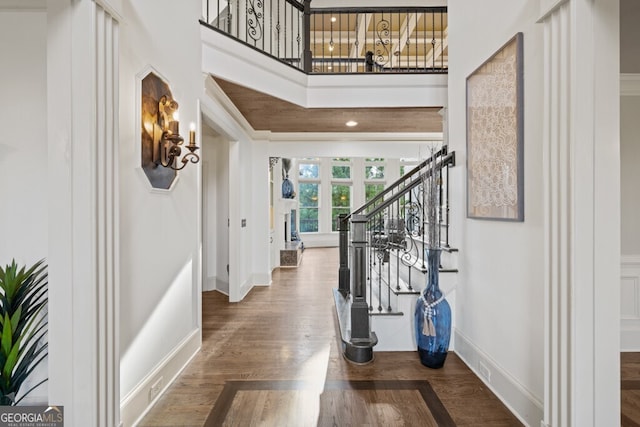 3491 Falls Branch Ct, Buford, GA 30519 - foyer entrance featuring baseboards, wood finished floors, stairway, and a high ceiling