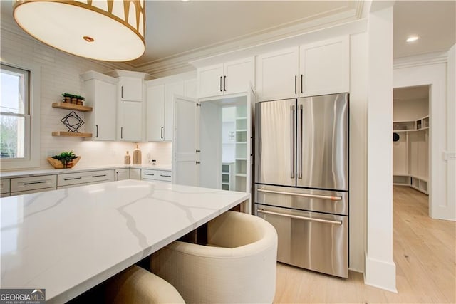 kitchen featuring open shelves, high end refrigerator, light wood finished floors, and white cabinetry