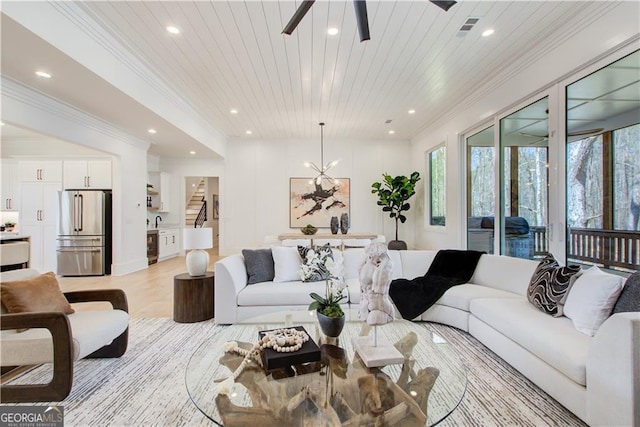 living room featuring stairs, recessed lighting, a ceiling fan, visible vents, and ornamental molding