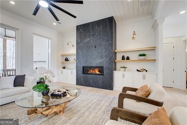living area with a fireplace, recessed lighting, a ceiling fan, and light wood-type flooring