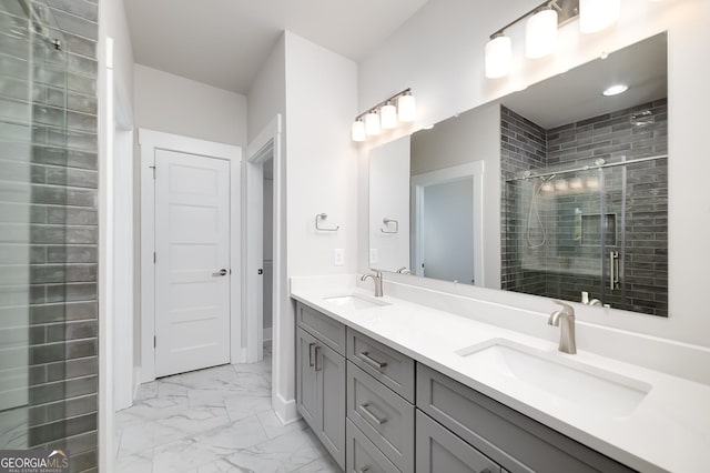 full bath with a sink, a shower stall, marble finish floor, and double vanity