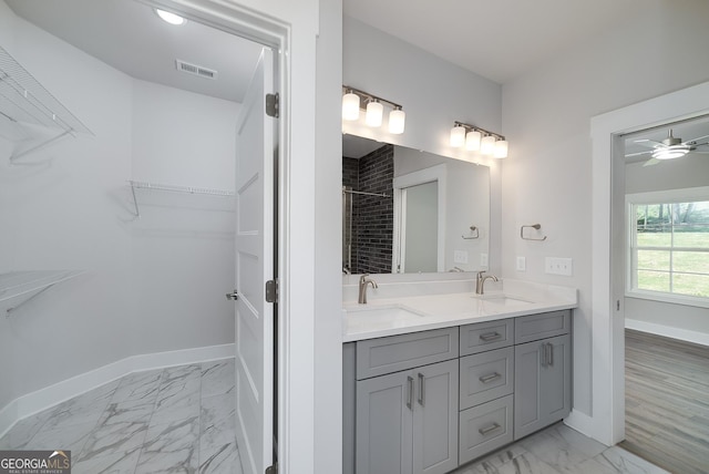 full bathroom with a spacious closet, visible vents, marble finish floor, and a sink