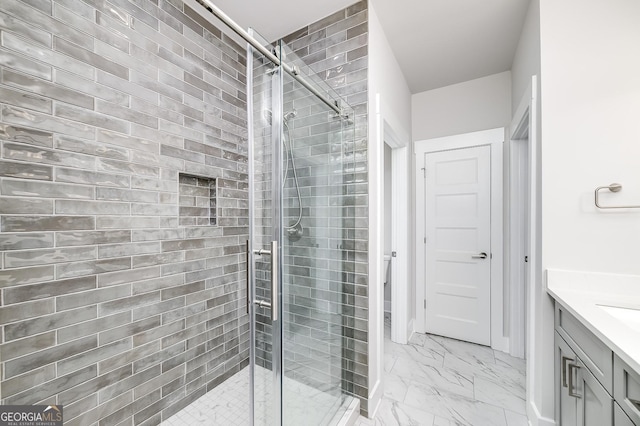 bathroom with vanity, marble finish floor, and a stall shower