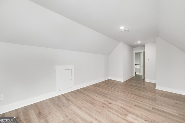 bonus room featuring visible vents, baseboards, wood finished floors, and lofted ceiling