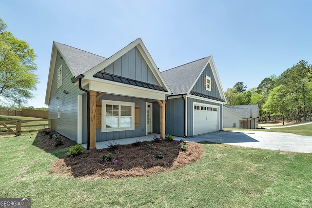 view of front of property with a front yard, a shingled roof, board and batten siding, fence, and driveway