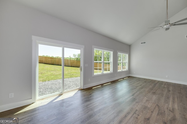 unfurnished living room with dark wood-type flooring, visible vents, a wealth of natural light, and a ceiling fan