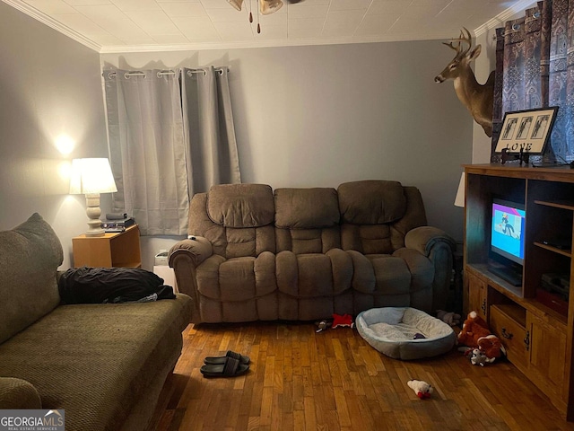 living room with wood-type flooring, a ceiling fan, and ornamental molding