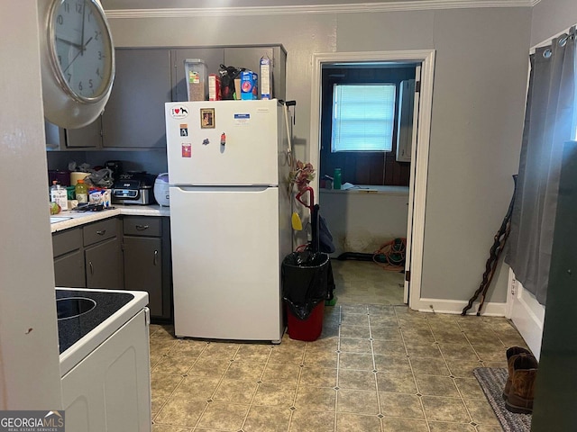 kitchen featuring tile patterned floors, gray cabinets, ornamental molding, and white appliances