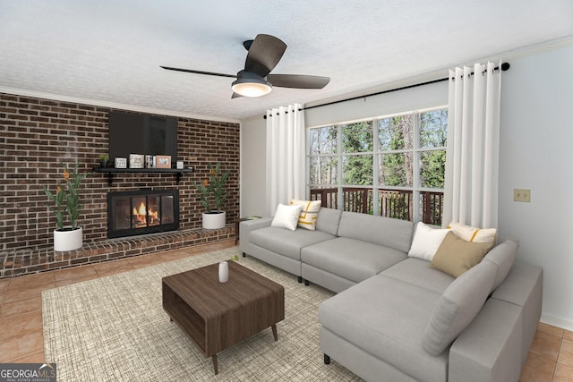 tiled living room featuring a textured ceiling, ceiling fan, brick wall, and a fireplace