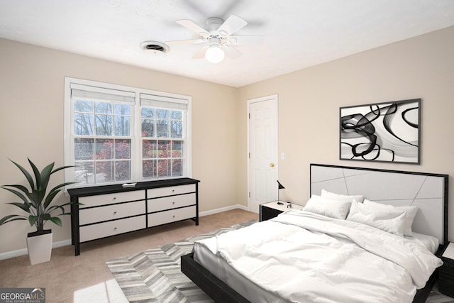bedroom featuring baseboards, light carpet, and ceiling fan