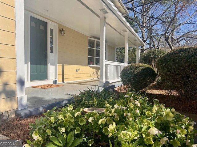 traditional home with fence, an attached garage, driveway, a front lawn, and a porch