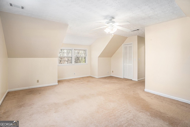 bonus room with baseboards, a ceiling fan, lofted ceiling, and visible vents