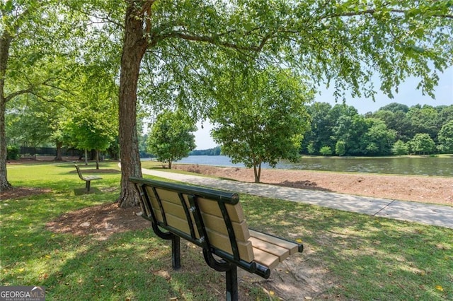 view of home's community featuring a water view and a yard