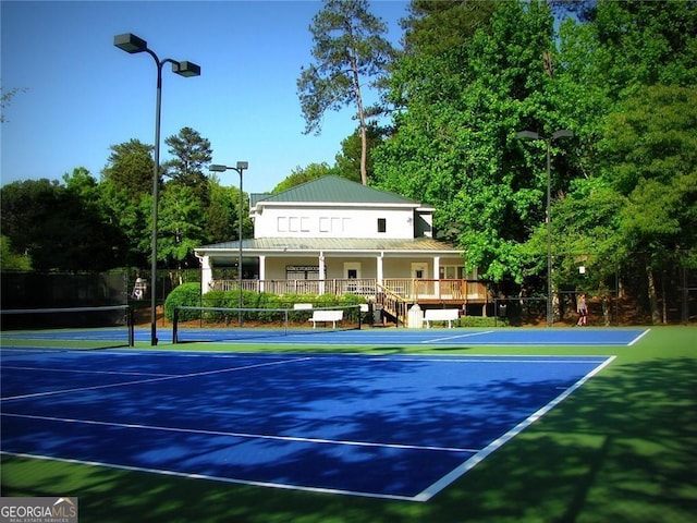view of tennis court featuring fence