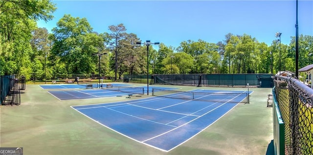 view of sport court featuring fence