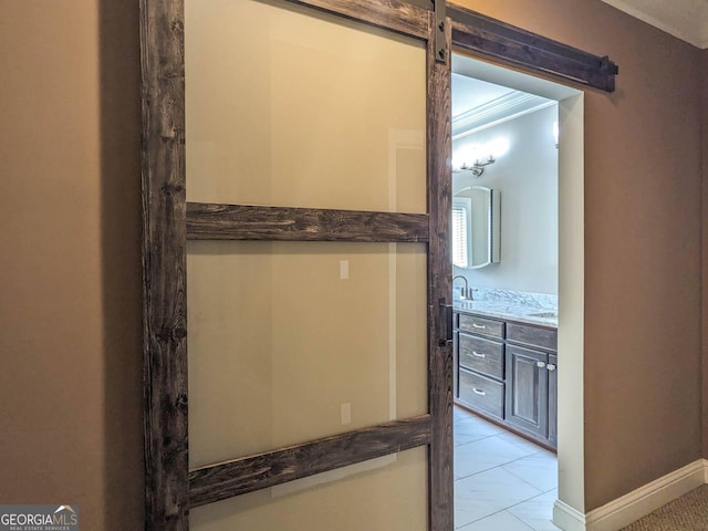bathroom with tile patterned floors, baseboards, and vanity
