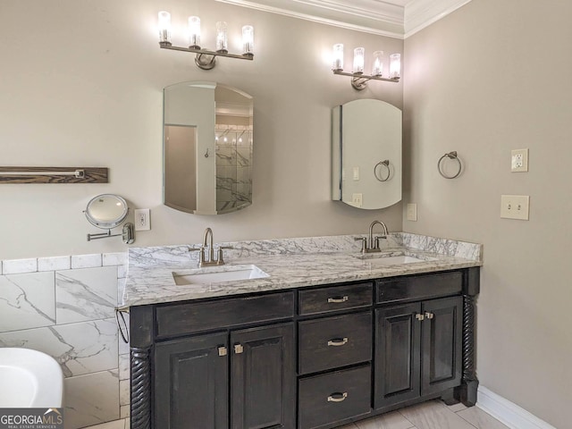 bathroom with a sink, tile walls, double vanity, and crown molding
