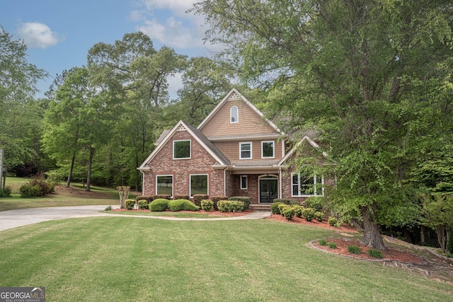 craftsman-style home with brick siding and a front lawn