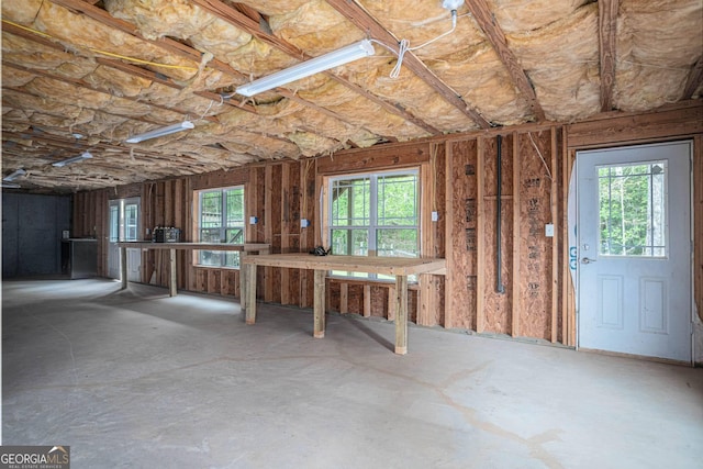 misc room with unfinished concrete flooring