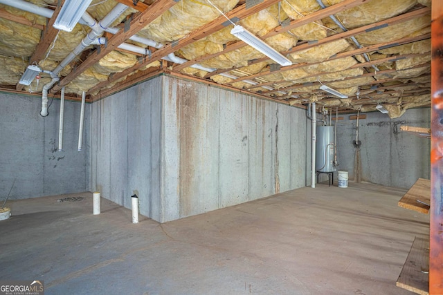 unfinished basement featuring water heater