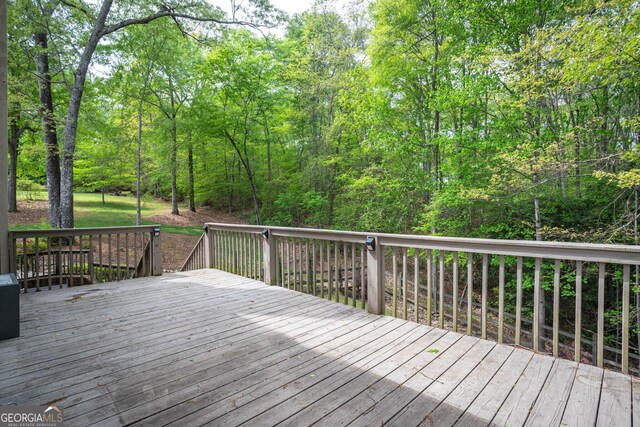 wooden deck with a forest view