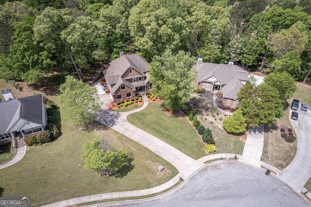 birds eye view of property with a wooded view