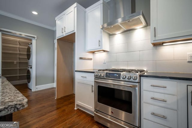 215 Chapman Pl, Athens, GA 30606 - kitchen featuring under cabinet range hood, stainless steel range with gas stovetop, stacked washer / drying machine, crown molding, and decorative backsplash