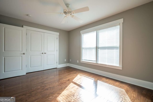 215 Chapman Pl, Athens, GA 30606 - unfurnished bedroom with a closet, dark wood finished floors, and a ceiling fan
