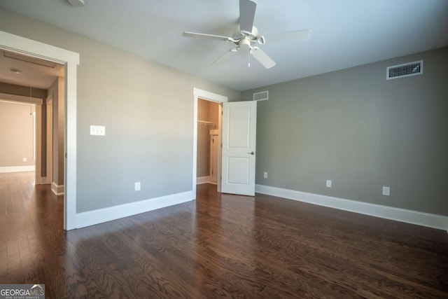 215 Chapman Pl, Athens, GA 30606 - unfurnished bedroom with dark wood-style floors, a spacious closet, a ceiling fan, and attic access