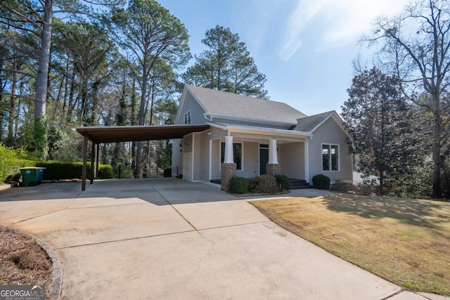 215 Chapman Pl, Athens, GA 30606 - craftsman house featuring a porch, concrete driveway, a carport, a front yard, and a shingled roof