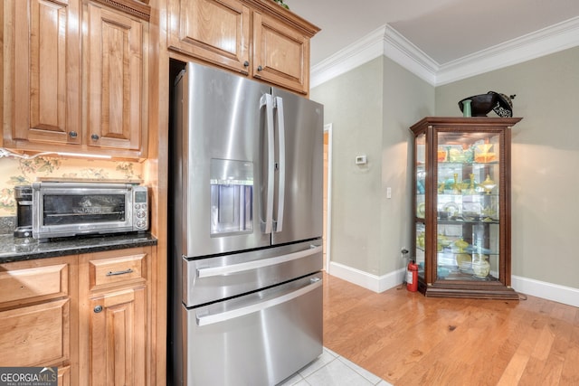 1649-H Lakeview Dr, Young Harris, GA 30582 - kitchen featuring stainless steel refrigerator with ice dispenser, baseboards, crown molding, light wood-style flooring, and dark stone counters
